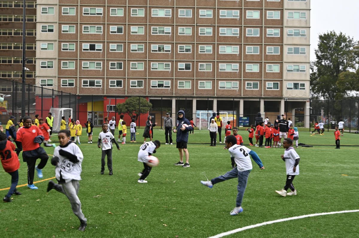 A junior match in progress on the pitch beside the Richmond housing estate